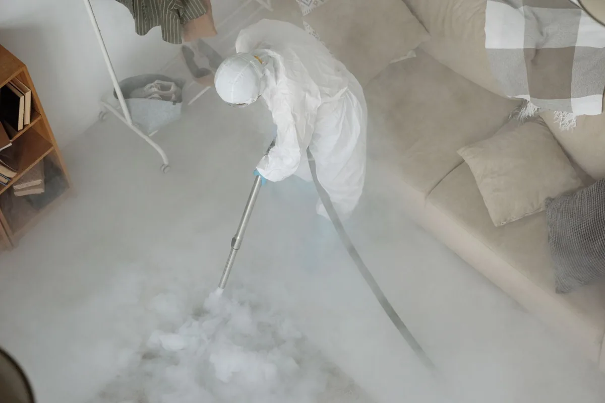 Biohazard cleanup technician in protective equipment, Grand Meadow, MN